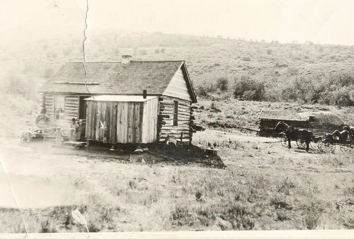 Before: faded black-and-white photo of a log cabin and horse-drawn wagon on open hills