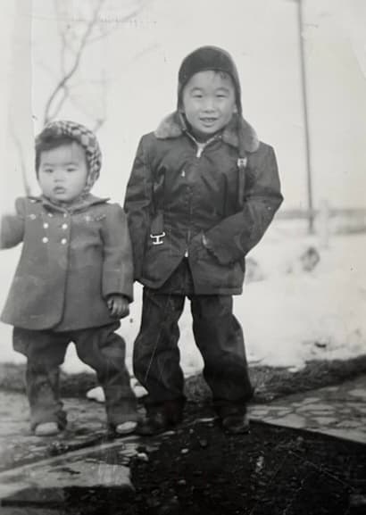 Before: two young children in winter coats, 1940s black-and-white snapshot
