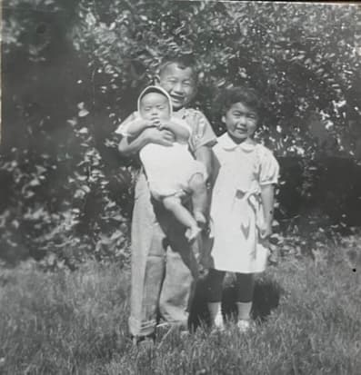 Faded vintage group photograph of siblings with dust and surface wear before restoration.